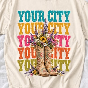 Tan cowboy boots with lavender and wildflowers over a five-line stacked personalized city word in retro colors
