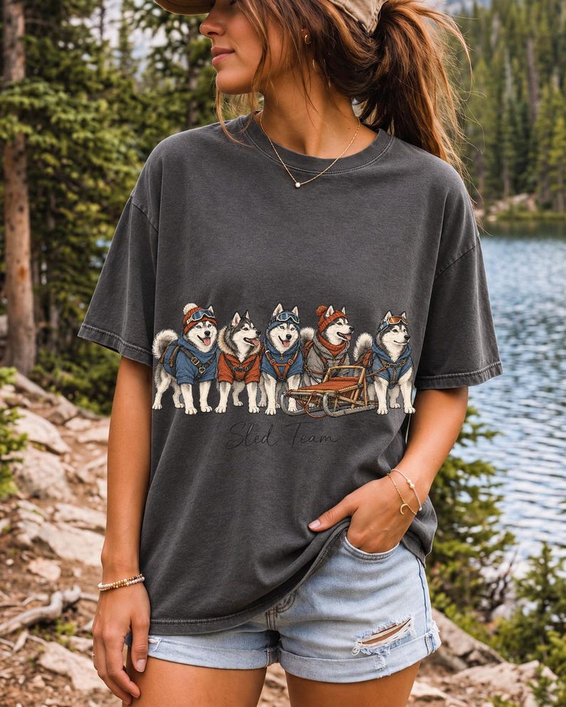 Illustrated huskies in ski gear lined up with a sled, text Sled Team