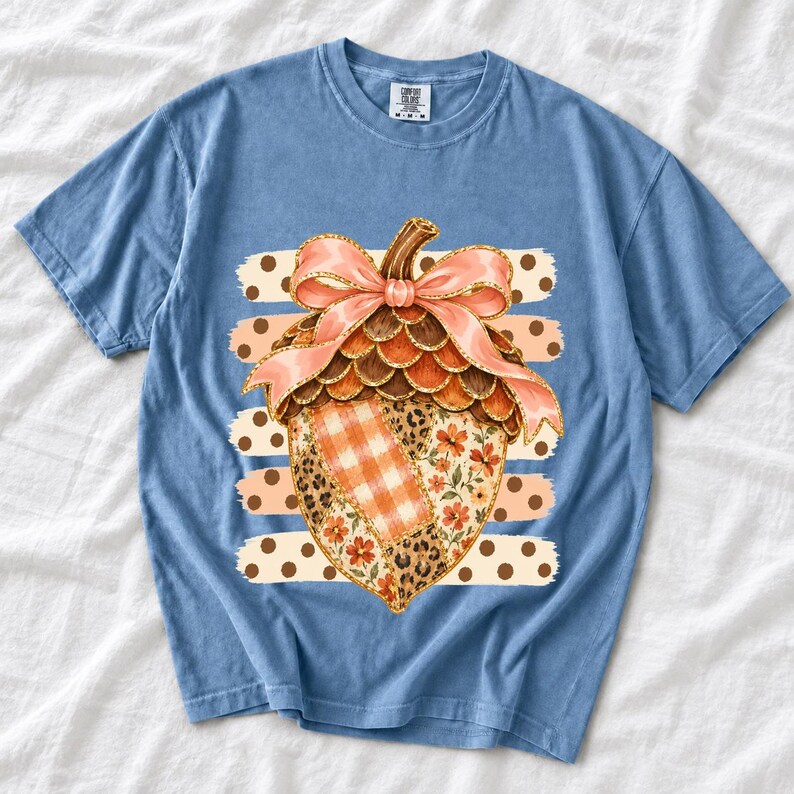 Giant patchwork acorn with a pink satin bow made of plaid, leopard and floral fabric on polka-dot stripes