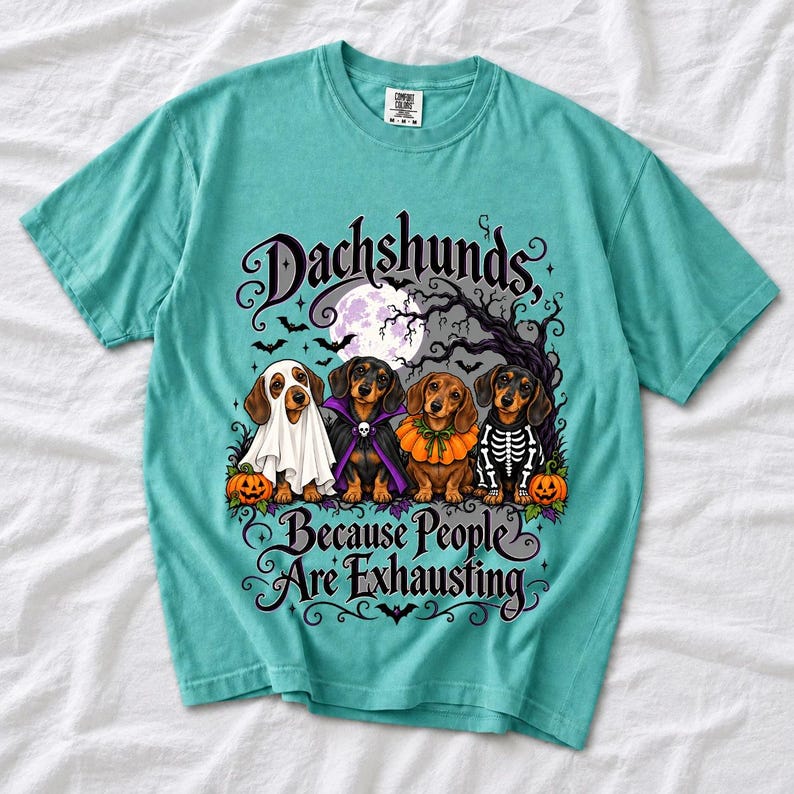 Four dachshunds in Halloween costumes under a spooky tree with text Dachshunds, Because People Are Exhausting