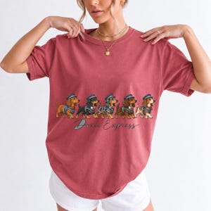 Illustrated dachshunds in conductor hats lined up like a train, text Doxie Express