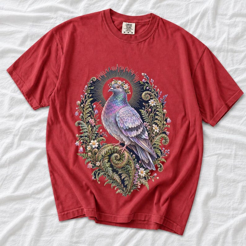 Painted pigeon wearing a daisy crown and glowing halo standing on a fern frond, whimsical cottagecore bird t-shirt art