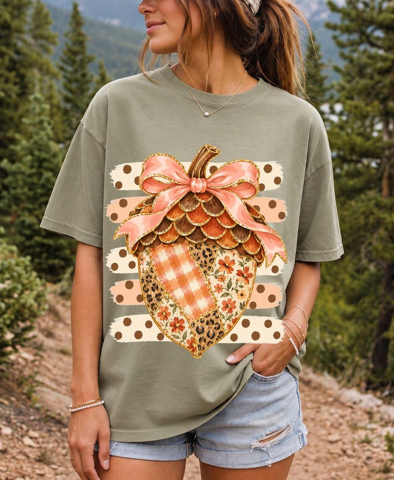 Giant patchwork acorn with a pink satin bow made of plaid, leopard and floral fabric on polka-dot stripes