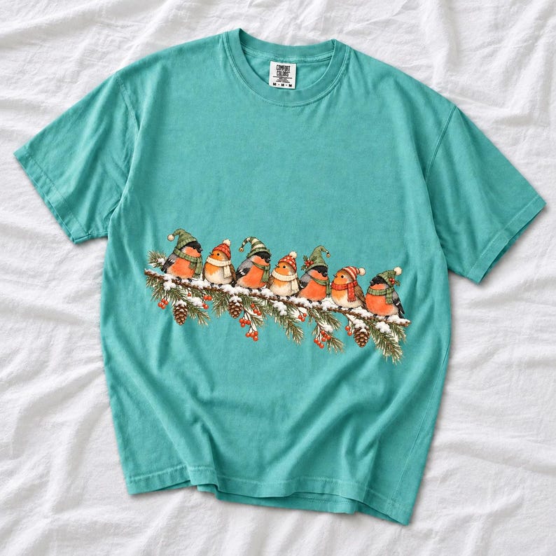 Watercolor bullfinches and robins in elf hats and scarves on a snowy pine branch