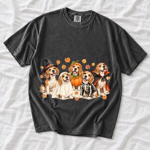 Five watercolor beagles in witch, ghost, pumpkin, skeleton and vampire costumes with floating autumn leaves