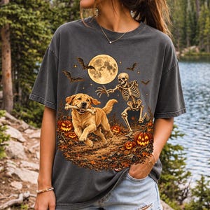 A skeleton chasing a golden labrador that stole its arm bone under a full moon with jack o lanterns and bats