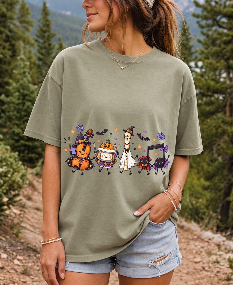 Kawaii violin, drum, recorder and notes with faces in Halloween costumes, pastel purple and orange