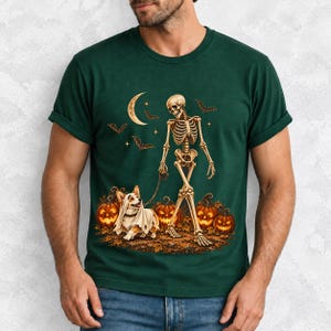A skeleton walking a corgi in a ghost costume past carved pumpkins under a crescent moon