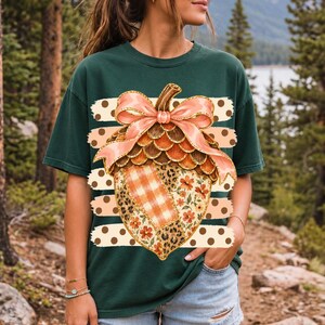 Giant patchwork acorn with a pink satin bow made of plaid, leopard and floral fabric on polka-dot stripes
