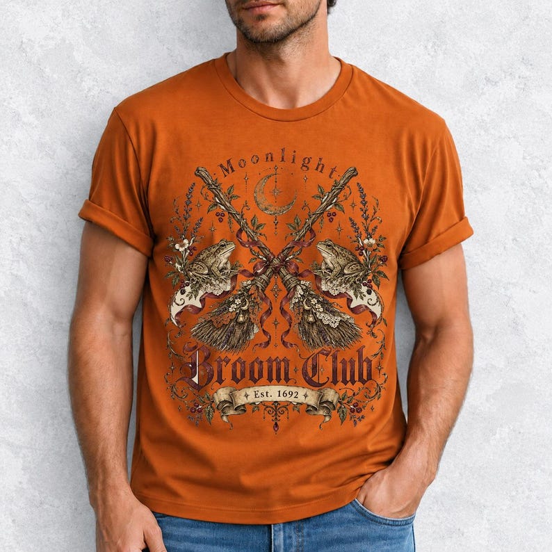 Vintage poster style crossed broomsticks with ribbons, lace and toads, text Moonlight Broom Club Est. 1692