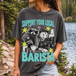 Raccoon and opossum behind an espresso machine, zine collage, text "Support Your Local Barista"
