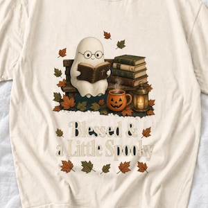 Cute ghost with glasses reading a Bible with a candle and mug, text "Blessed & a Little Spooky", retro fall illustration