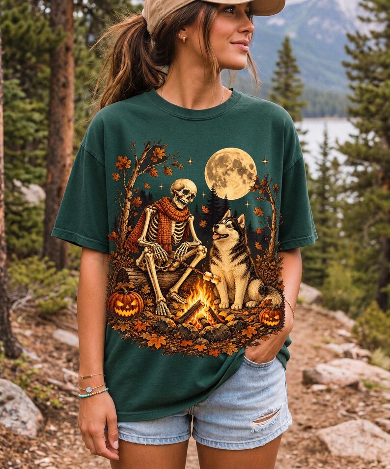A skeleton in a scarf roasting marshmallows by a campfire beside a husky in an autumn forest under a full moon