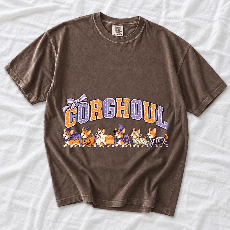 Six corgis in Halloween costumes walking under the arched word CORGHOUL, lavender and orange polka-dot varsity style