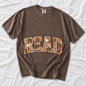 Arched varsity word READ filled with tiny books and autumn leaves in cream, rust and mustard
