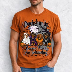Four dachshunds in Halloween costumes under a spooky tree with text Dachshunds, Because People Are Exhausting