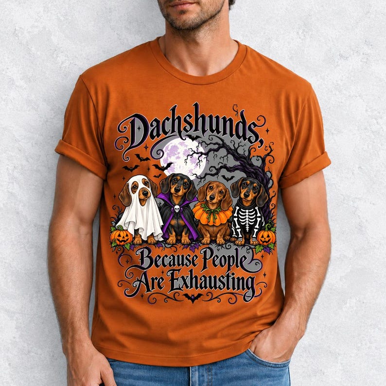 Four dachshunds in Halloween costumes under a spooky tree with text Dachshunds, Because People Are Exhausting