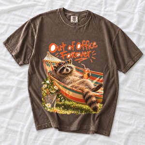 Raccoon relaxing in a hammock with a soda can and sunglasses, 90s film photo style, text "Out of Office Forever"