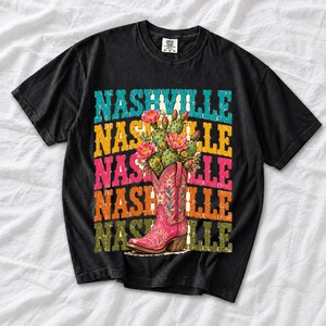Pink embroidered cowboy boot with blooming cactus over a five-line stacked NASHVILLE word in retro colors