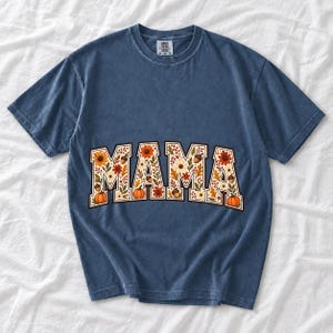 Arched varsity word MAMA filled with fall flowers and acorns in cream, rust and mustard
