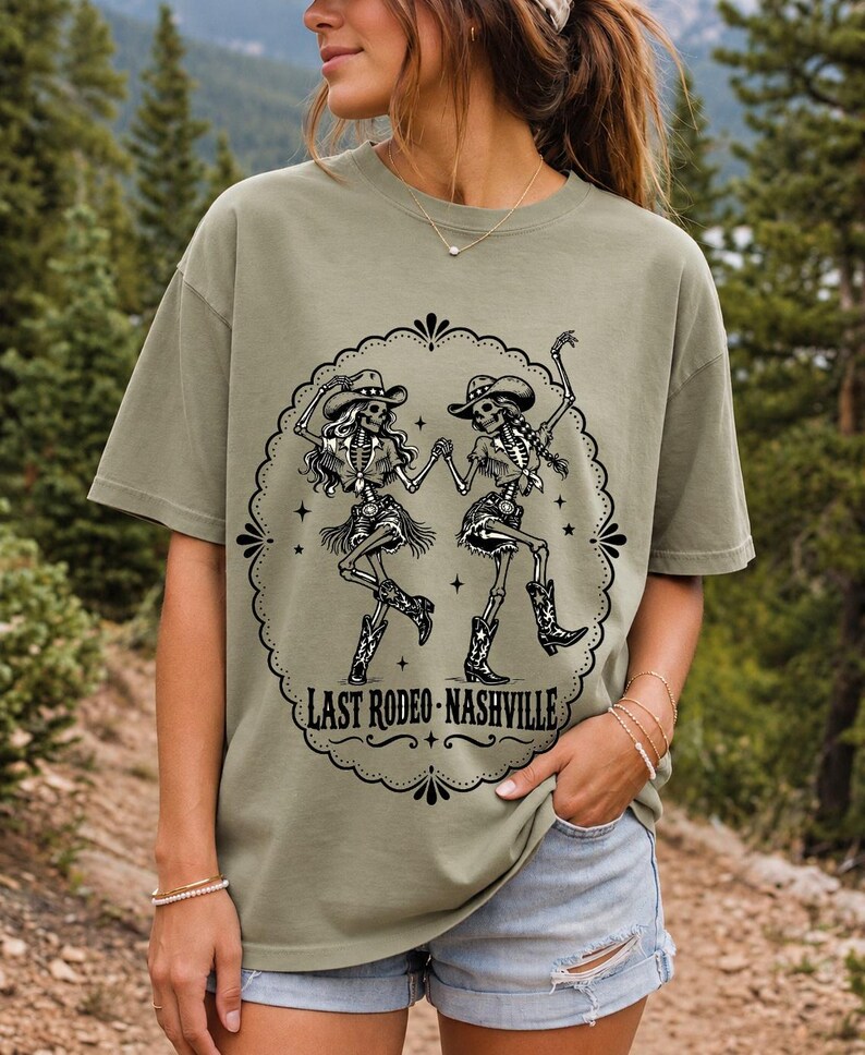 Two cowgirl skeletons in hats line dancing in a starry frame with the text Last Rodeo Nashville