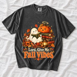 Smiling pumpkin with a halo beside a stack of books and a lantern, text "Lord, Give Me Fall Vibes", retro fall illustration