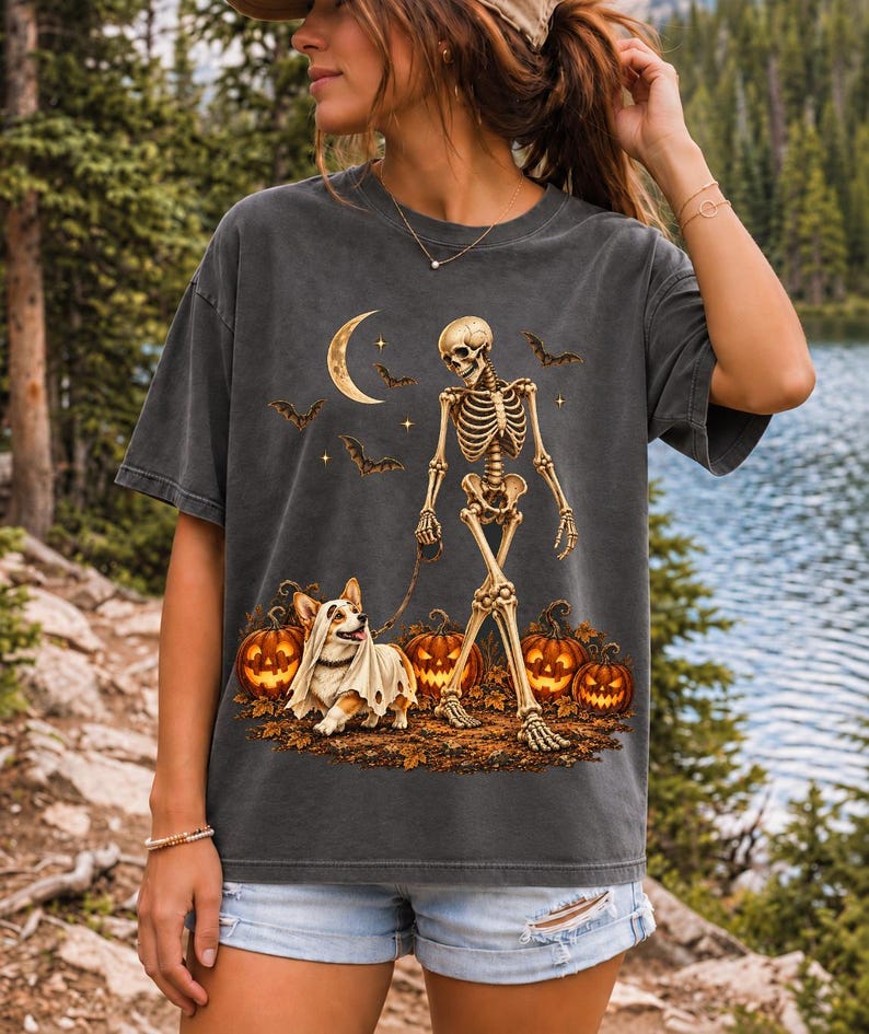 A skeleton walking a corgi in a ghost costume past carved pumpkins under a crescent moon