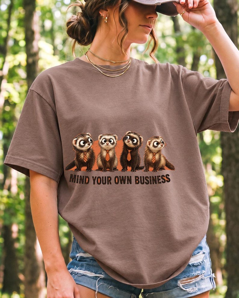 Four ferrets in tiny ties in a row with the text "Mind Your Own Business"