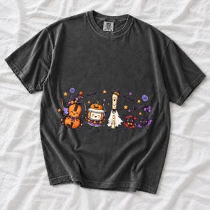 Kawaii violin, drum, recorder and notes with faces in Halloween costumes, pastel purple and orange