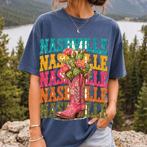 Pink embroidered cowboy boot with blooming cactus over a five-line stacked NASHVILLE word in retro colors