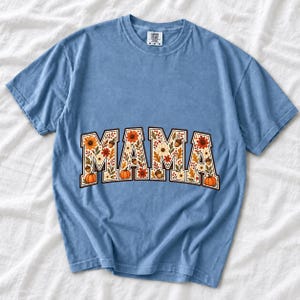 Arched varsity word MAMA filled with fall flowers and acorns in cream, rust and mustard