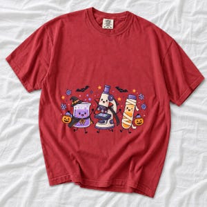 Kawaii beaker, microscope and test tube with faces in Halloween costumes, pastel purple and orange