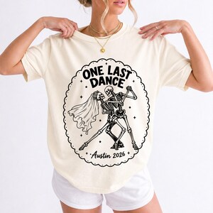 Two skeletons dancing tango, one in a veil, in a starry frame with the text One Last Dance Austin 2026