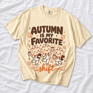 Cute pumpkin characters in nurse caps with clipboards and coffee, text Autumn Is My Favorite Shift