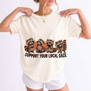 Four raccoons in a row with the text "Support Your Local Gaze"