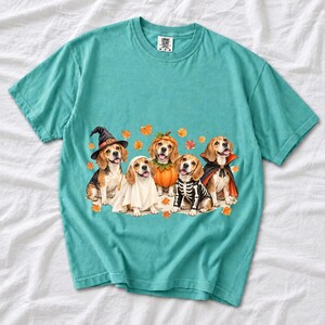 Five watercolor beagles in witch, ghost, pumpkin, skeleton and vampire costumes with floating autumn leaves