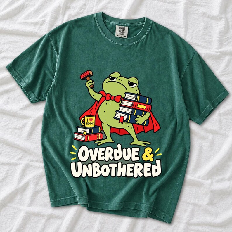 Grumpy cartoon frog librarian holding a stamp and a stack of books with the text Overdue & Unbothered
