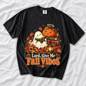 Smiling pumpkin with a halo beside a stack of books and a lantern, text "Lord, Give Me Fall Vibes", retro fall illustration