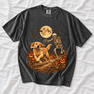 A skeleton chasing a golden labrador that stole its arm bone under a full moon with jack o lanterns and bats