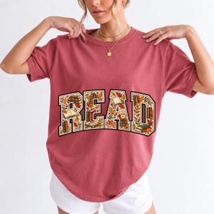 Arched varsity word READ filled with tiny books and autumn leaves in cream, rust and mustard