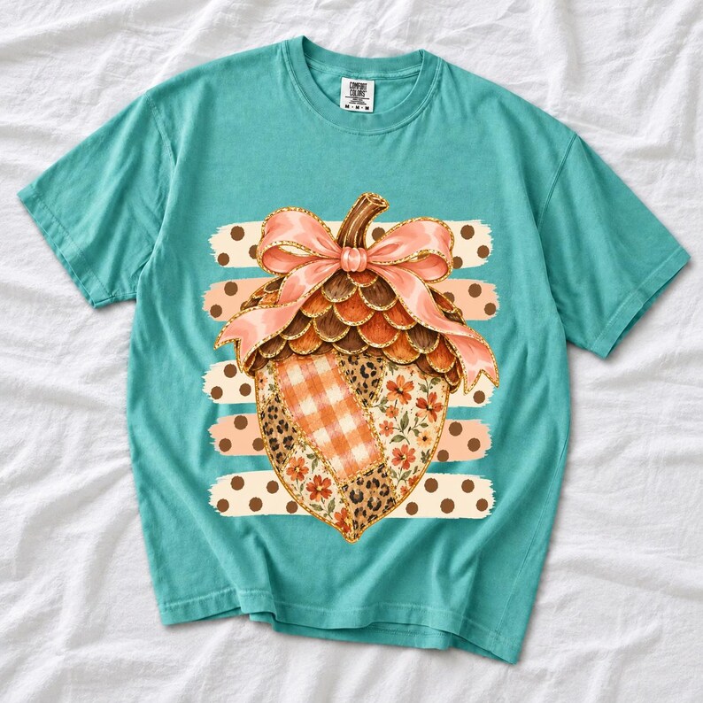 Giant patchwork acorn with a pink satin bow made of plaid, leopard and floral fabric on polka-dot stripes