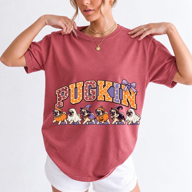 Six pugs in pumpkin, ghost and witch costumes under the arched word PUGKIN, lavender and orange polka-dot varsity style