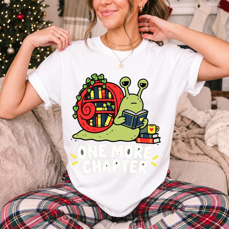 Cartoon snail reading a book with a bookshelf shell and the text One More Chapter