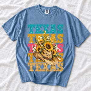 Straw cowboy hat full of sunflowers over a five-line stacked TEXAS word in retro western colors