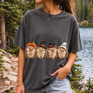Realistic illustration of four hedgehogs wearing tiny Halloween hats in a row