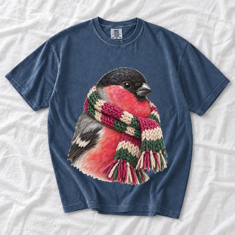 Colored-pencil bullfinch bird wrapped in a chunky striped knit scarf, cozy winter birdwatcher t-shirt art