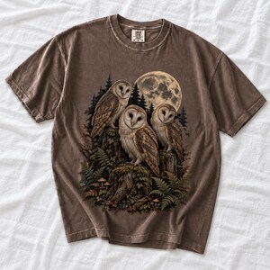 Three barn owls on a mossy stump under a huge full moon with ferns and mushrooms, dark realistic forest illustration