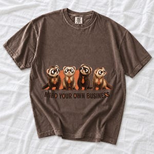 Four ferrets in tiny ties in a row with the text "Mind Your Own Business"