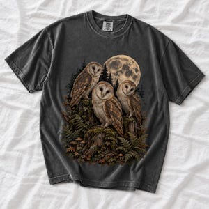 Three barn owls on a mossy stump under a huge full moon with ferns and mushrooms, dark realistic forest illustration