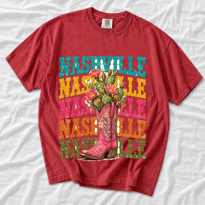 Pink embroidered cowboy boot with blooming cactus over a five-line stacked NASHVILLE word in retro colors